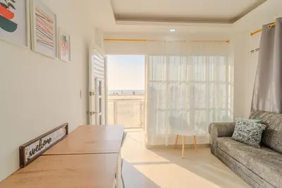 a living room with a couch and a large window at Apartamentos el mochilero frente a la playa piso 1 apto 1 in Cartagena de Indias