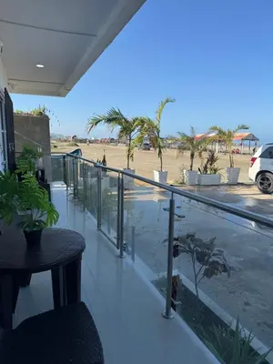 a balcony with a table and a view of a beach at Apartamentos el mochilero frente a la playa piso 1 apto 1 in Cartagena de Indias