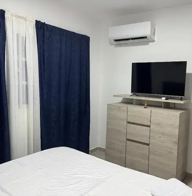 a bedroom with a bed and a tv on a dresser at Apartamentos el mochilero frente a la playa piso 1 apto 1 in Cartagena de Indias