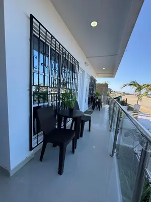 a balcony with a table and chairs on a building at Apartamentos el mochilero frente a la playa piso 1 apto 1 in Cartagena de Indias