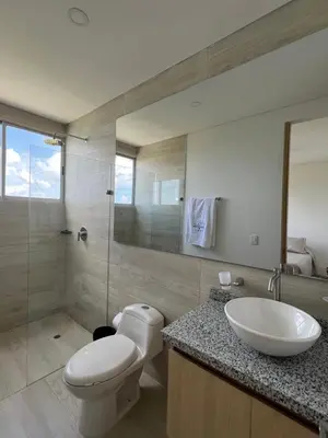 a bathroom with a toilet and a sink and a shower at Apartamento Torre Vela- Coveñas in Coveñas