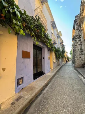 an empty street with a yellow and purple building at Hotel Villa Alta Guest House in Cartagena de Indias
