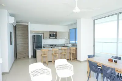 a kitchen and dining room with a table and chairs at Magico Apartamento Frente al Mar 3 Habitaciones PAZ282 in Coveñas