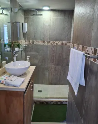a bathroom with a sink and a glass shower at Apartamento vacacional El Laguito Cartagena in Cartagena de Indias