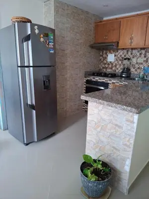 a kitchen with a stainless steel refrigerator and a counter at Apartamento vacacional El Laguito Cartagena in Cartagena de Indias