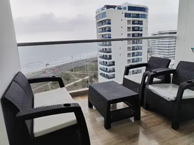 a balcony with chairs and a table and a view of the ocean at Aparta Suite en Cartagena de Indias in Cartagena de Indias
