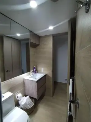 a bathroom with a sink and a toilet and a mirror at Aparta Suite en Cartagena de Indias in Cartagena de Indias