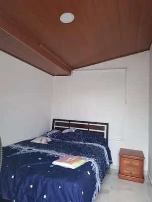 a bedroom with a bed and a wooden ceiling at Habitación Caracol in Barranquilla