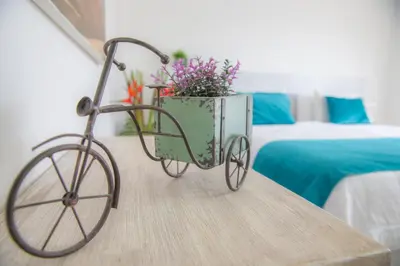 a bike with a basket filled with flowers on a table at Hotel Boutique La Artilleria in Cartagena de Indias