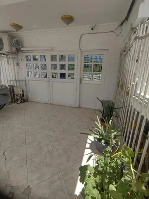 a large room with two garage doors and plants at La fantástica Mi Hostal in Cartagena de Indias