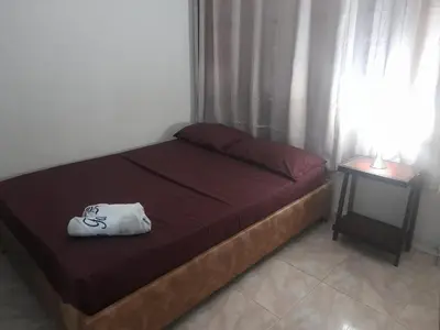 a bedroom with a bed with a bag on it at La fantástica Mi Hostal in Cartagena de Indias