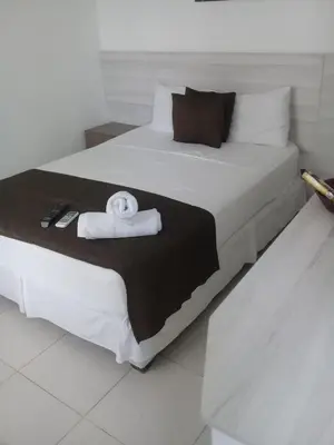 a large white bed with a towel on it at Mintaka Hotel + Lounge in Cartagena de Indias