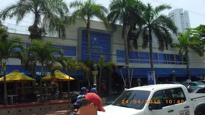 a man riding a bike in front of a building at Mintaka Hotel + Lounge in Cartagena de Indias