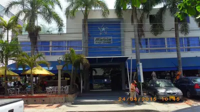 a building with palm trees in front of it at Mintaka Hotel + Lounge in Cartagena de Indias