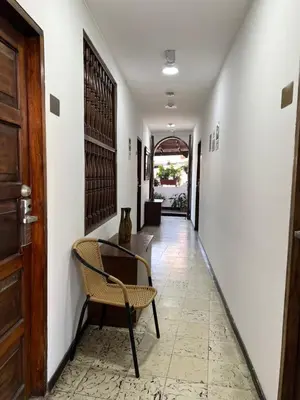 a hallway with a chair and a table at Santa Alejandría Hotel in Cartagena de Indias