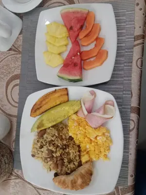two plates filled with different types of food on a table at Santa Alejandría Hotel in Cartagena de Indias