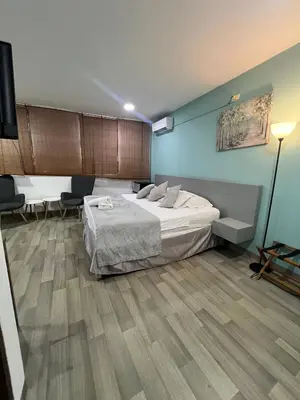 a bedroom with a large bed and wooden floors at Santa Alejandría Hotel in Cartagena de Indias