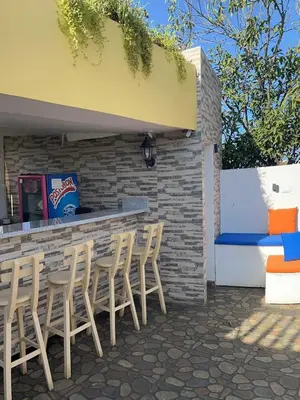 a group of chairs sitting in front of a bar at Zana Hotel Boutique in Cartagena de Indias