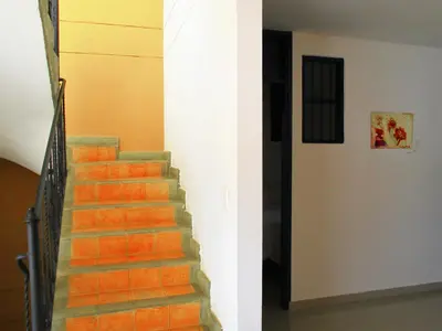 two images of a staircase in a building at Zana Hotel Boutique in Cartagena de Indias