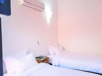 a hotel room with two beds and a night stand at Zana Hotel Boutique in Cartagena de Indias