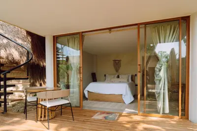 a bedroom with a bed and sliding glass doors at VelaNova Paradise - HotelRetreat in Isla Fuerte
