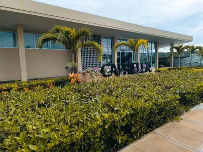 a building with palm trees and plants in front of it at Acogedor espacio -Serena del Mar in Cartagena de Indias