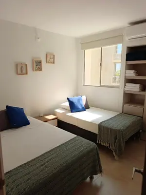 a bedroom with two beds and a window at Acogedor espacio -Serena del Mar in Cartagena de Indias