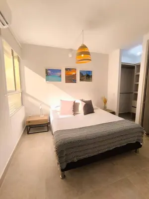 a bedroom with a bed and a pendant light at Acogedor espacio -Serena del Mar in Cartagena de Indias