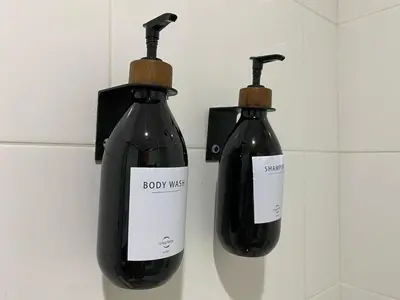 two bottles of wine hanging on a wall at Hotel Soleira in Tolú