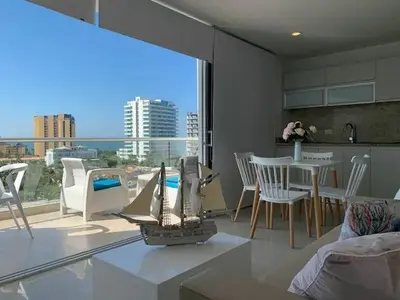a kitchen and living room with a view of the ocean at Apartamento Bello Horizonte Santamarta in Santa Marta