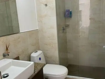 a bathroom with a toilet and a sink and a shower at Apartamento Bello Horizonte Santamarta in Santa Marta