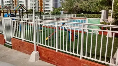 a white fence in front of a swimming pool at Habitación Canarios in Barranquilla