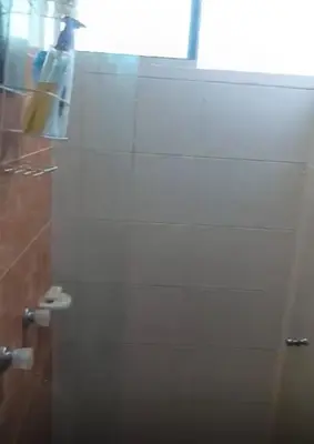 a bathroom with a shower with a glass door at Habitación Canarios in Barranquilla