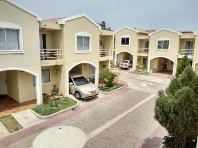 an apartment complex with a car parked in a parking lot at Habitación Colibrí in Barranquilla