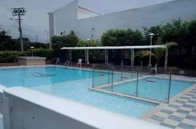 a large blue swimming pool with a pavilion at Habitación Colibrí in Barranquilla