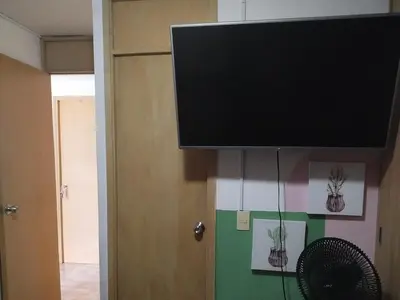 a flat screen tv hanging from a wall at La casita de jo in Cartagena de Indias