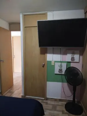 a flat screen tv hanging from a wall in a room at La casita de jo in Cartagena de Indias