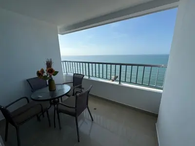 a balcony with a table and chairs and a view of the ocean at Apto Luxury cartagena 2401 Palmetto1 Frente al Mar in Cartagena de Indias