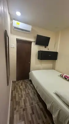 a small room with a bed and a door at Hostal la muralla getsemani in Cartagena de Indias