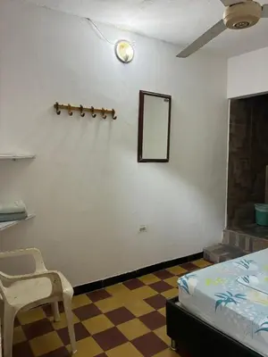 a bedroom with a bed and a mirror on a wall at Hostal la muralla getsemani in Cartagena de Indias