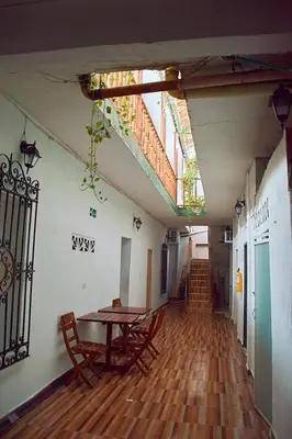 a room with a table and chairs in a building at Hostal la muralla getsemani in Cartagena de Indias