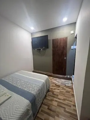 a bedroom with a bed and a flat screen tv at Hostal la muralla getsemani in Cartagena de Indias