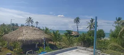 a view of a resort with palm trees and the ocean at Cabaña Flor de Loto in San Bernardo del Viento