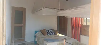 a bedroom with a bed and a window at Cabaña Flor de Loto in San Bernardo del Viento