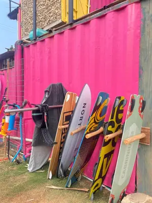 a bunch of surfboards are leaned up against a wall at Surf Mojarra Beach Habitación privada con vista al mar in Salina de Rey