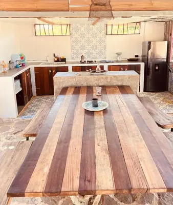 a kitchen with a wooden table with a plate on it at Surf Mojarra Beach Habitación privada con vista al mar in Salina de Rey