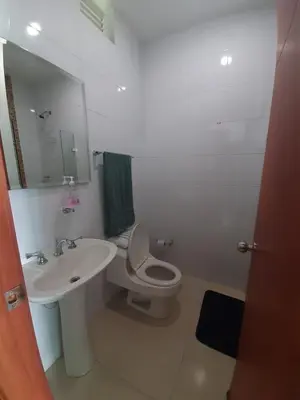 a white bathroom with a sink and a toilet at Apartamento Frente al Mar in Santa Marta
