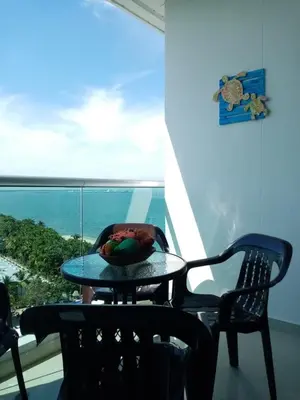 a table and chairs in a room with a window at Apartamento Frente al Mar in Santa Marta