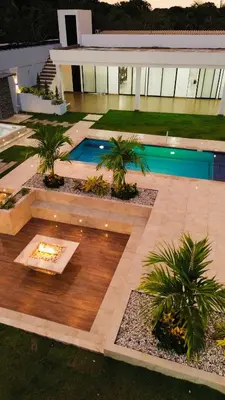 a courtyard with a pool and palm trees in front of a building at cabaña villa rags in Sabanagrande