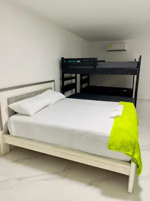 a bedroom with a bed with a yellow blanket on it at cabaña villa rags in Sabanagrande